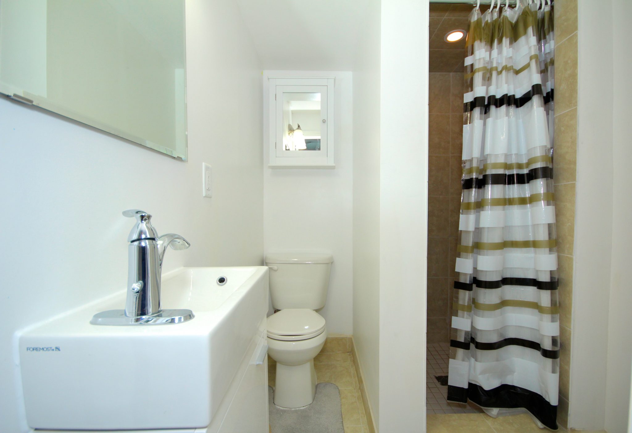 Bathroom with toilet seat and sink