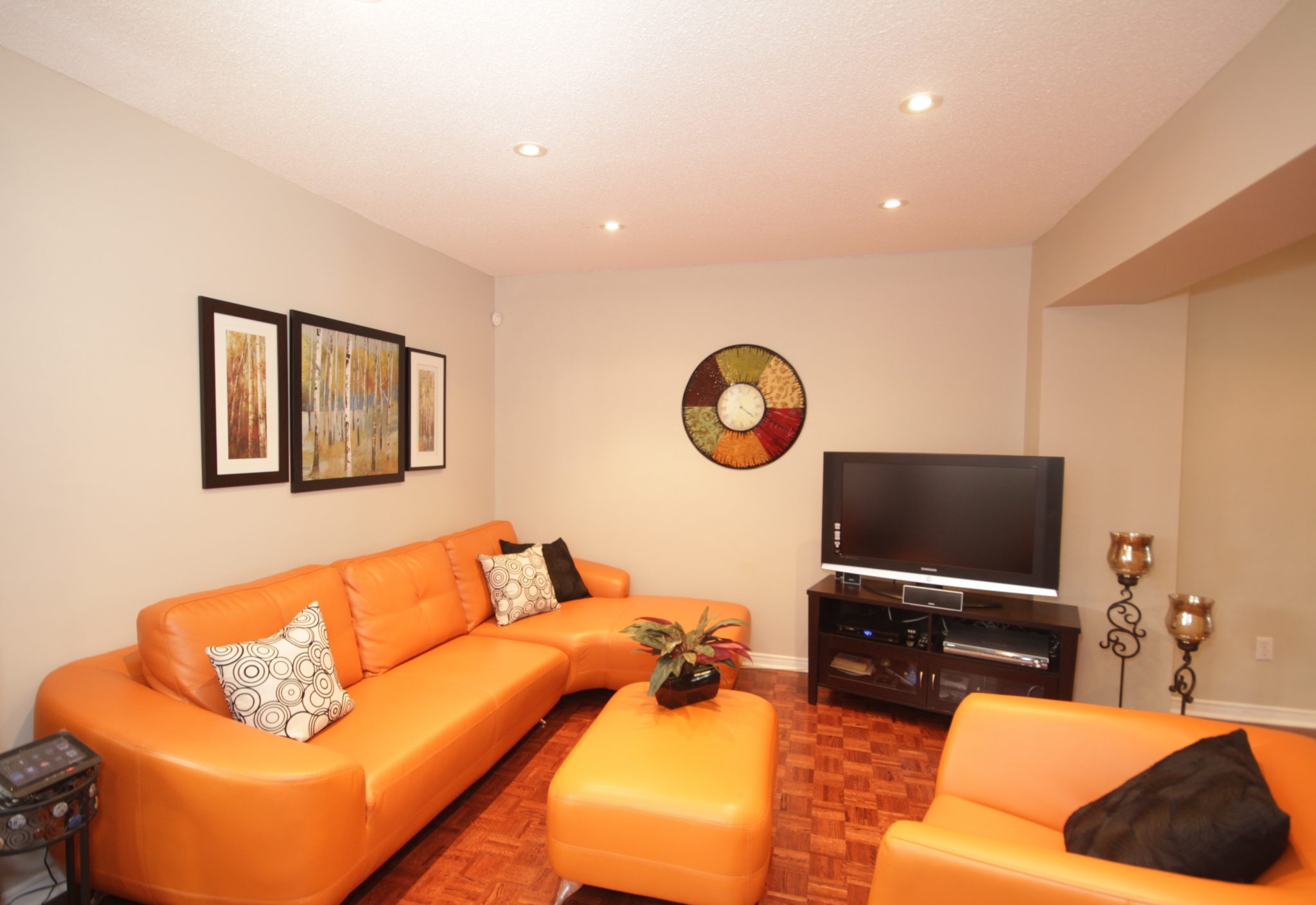 living room with orange color sofa