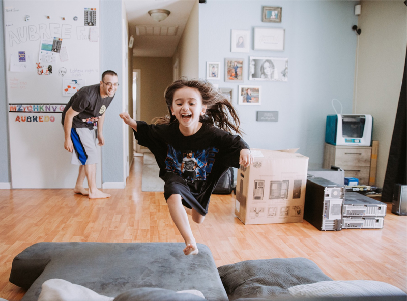 child jumping on the bed