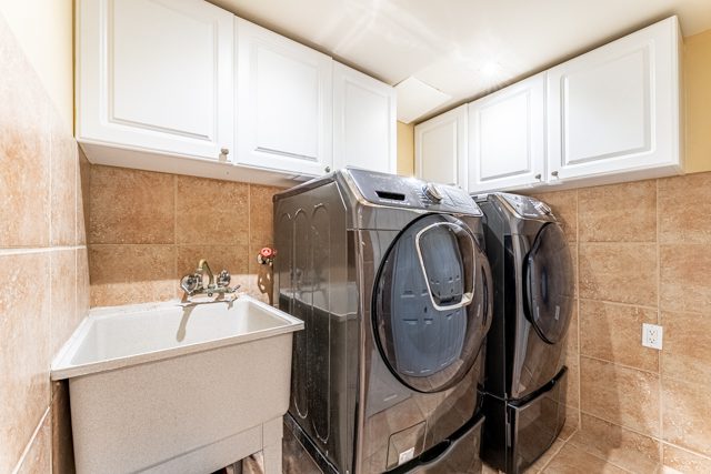 Laundry room with storage at 14 White Rd, Brampton
