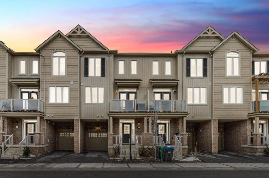 "Exterior view of modern executive townhouse in Southfield Village with landscaped front yard.