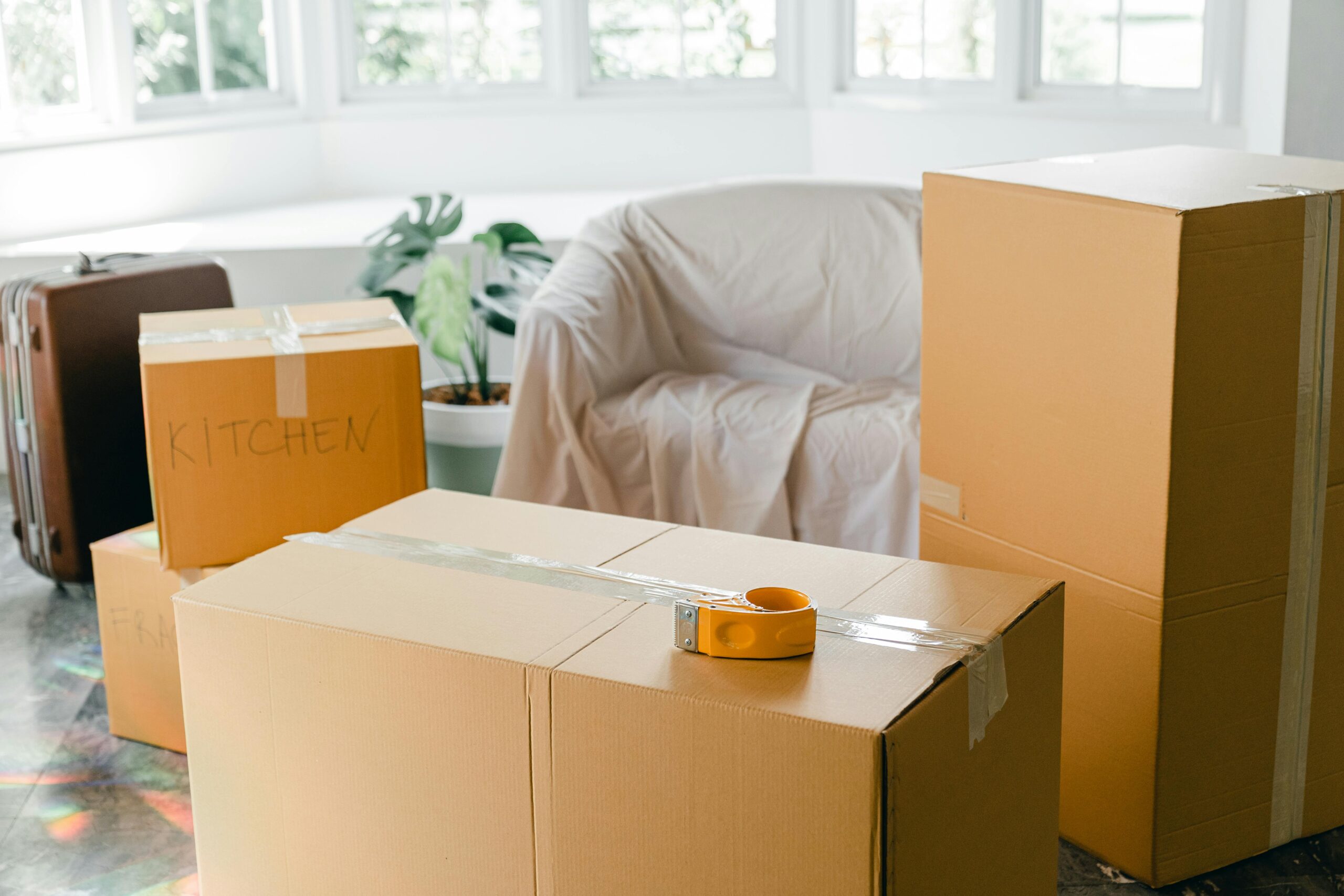 Moving boxes representing the condo vs bungalow downsizing decision.