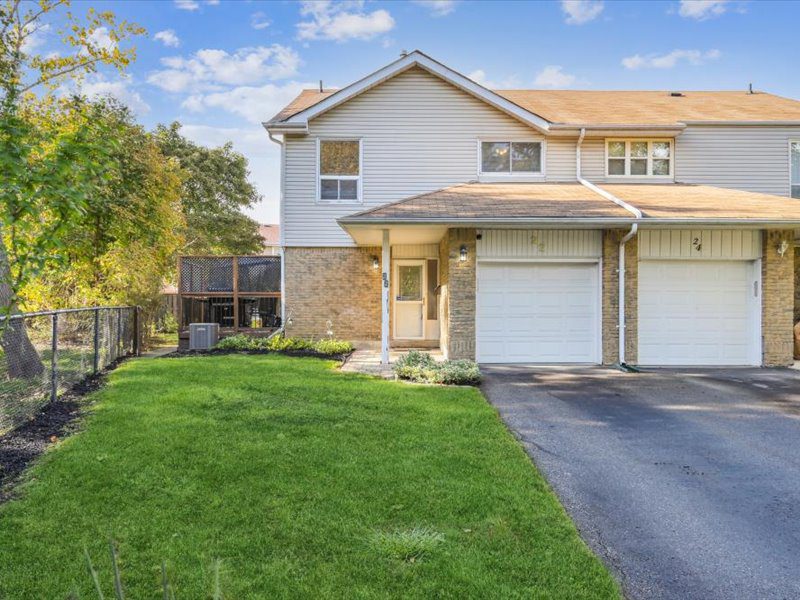 Front view of the semi-detached home at 22 Amberwood Square, Brampton, showing a well-maintained front lawn and driveway with attached garage.