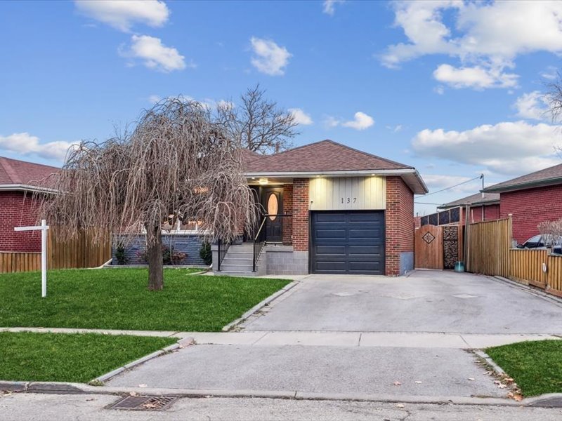 Front view of 137 Kingsview Blvd with brick exterior and private driveway.