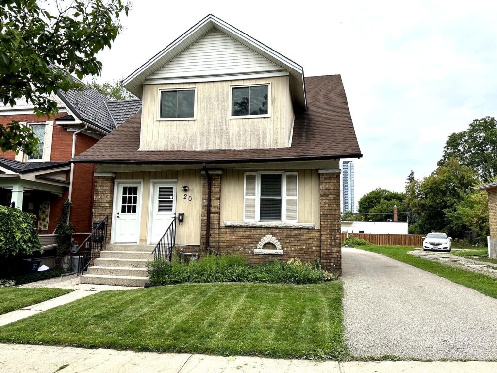 Front view of detached home at 20 Cameron Street North Kitchener with private driveway and lawn.