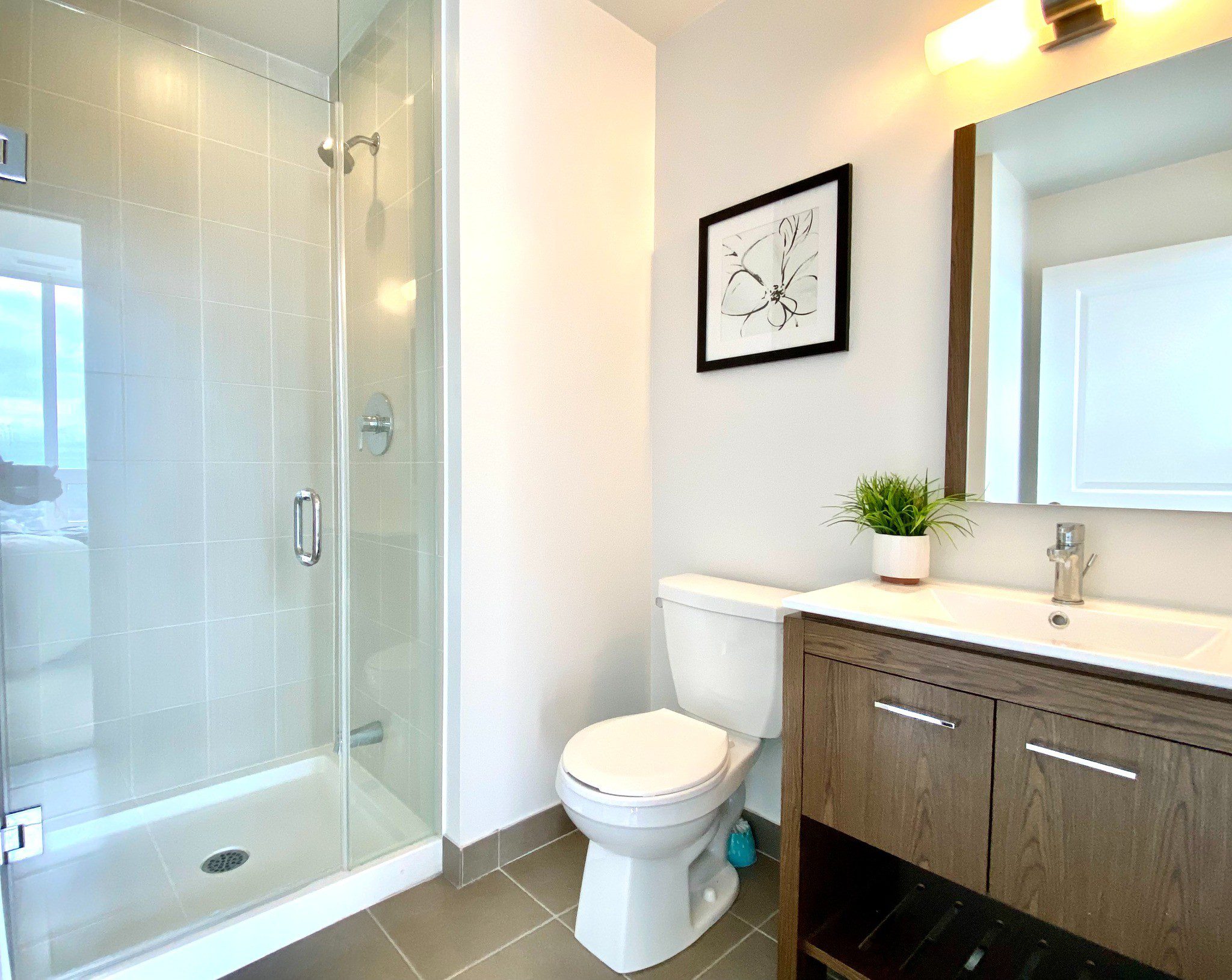 Contemporary ensuite bathroom with glass shower & vanity.