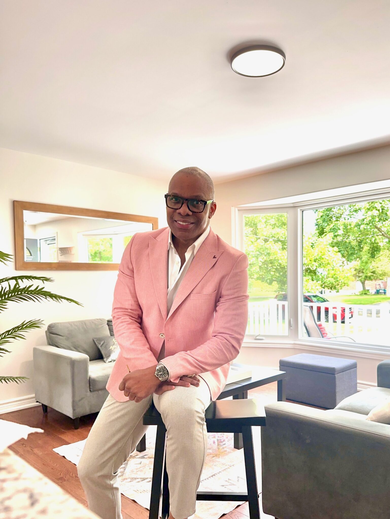 Keith Goldson in a bright living room of an entry-level home he is showing to first-time buyers in the GTA, Hamilton, and Niagara Region.