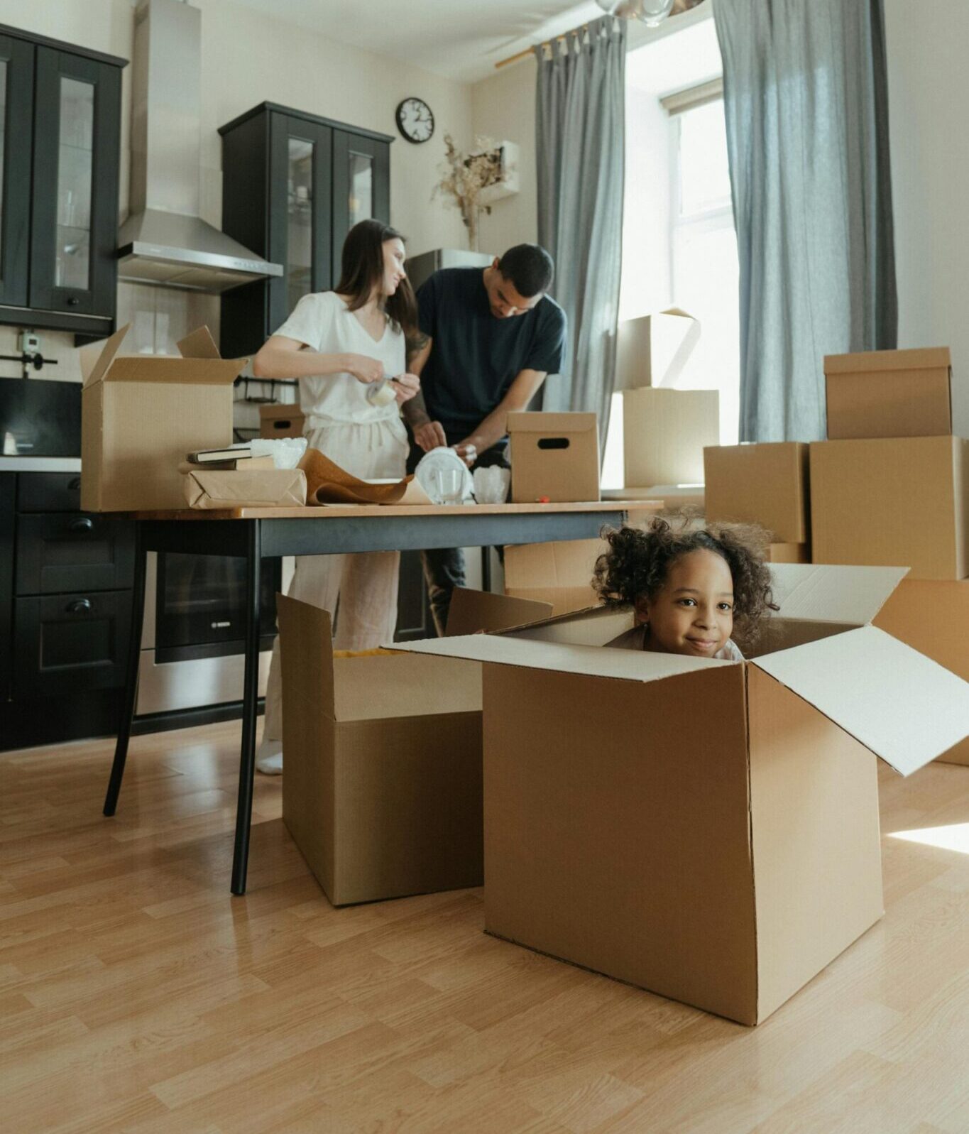 Family unpacking moving boxes in their new Ontario home