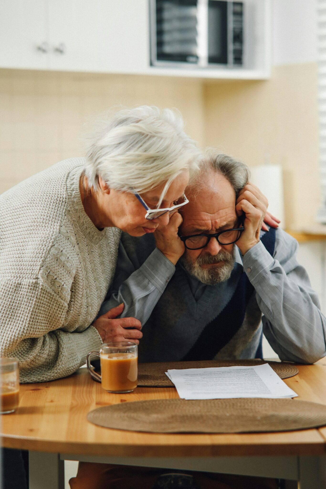 Ontario couple reviewing power of sale process notice documents at their kitchen table.