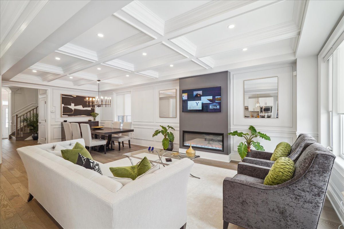 Professionally staged living room with coffered ceiling and modern fireplace in a Keith & Françoise listing