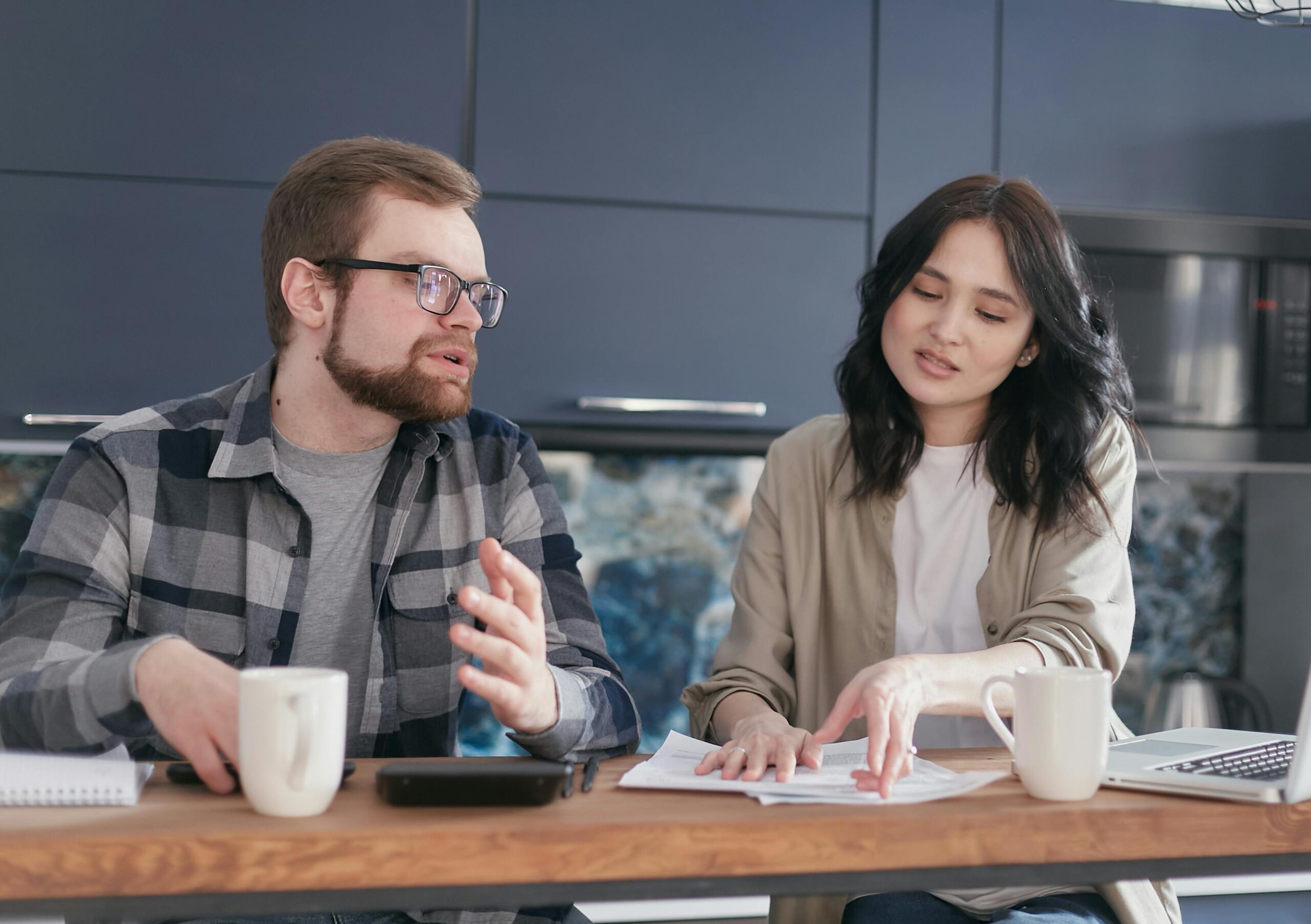 Newcomer reviewing rental documents at a table while preparing a rental application in Ontario.