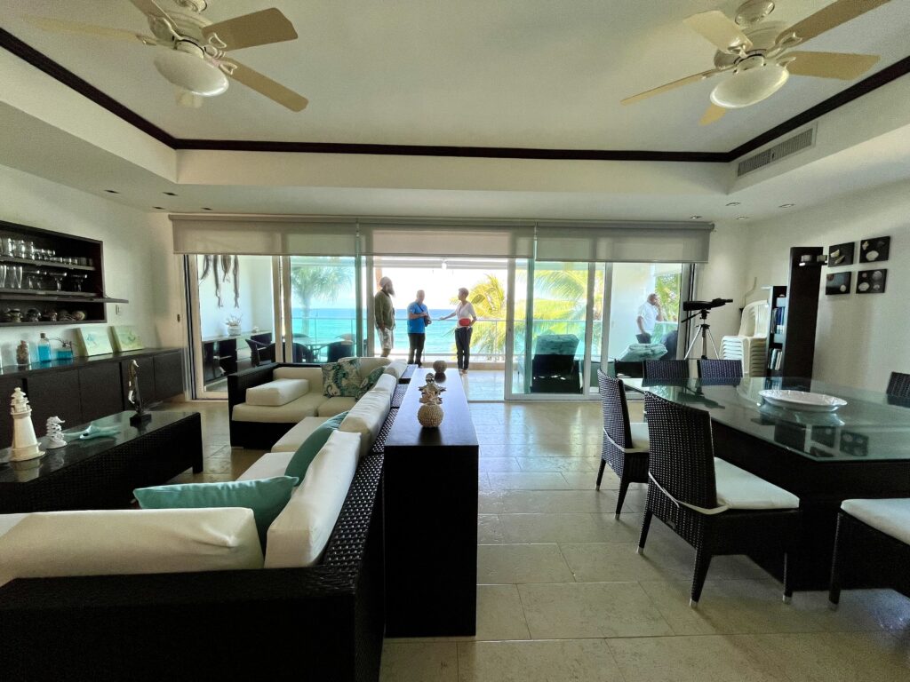 Interior of beachfront condo toured in Puerto Plata Dominican Republic with ocean view balcony and open plan living area.