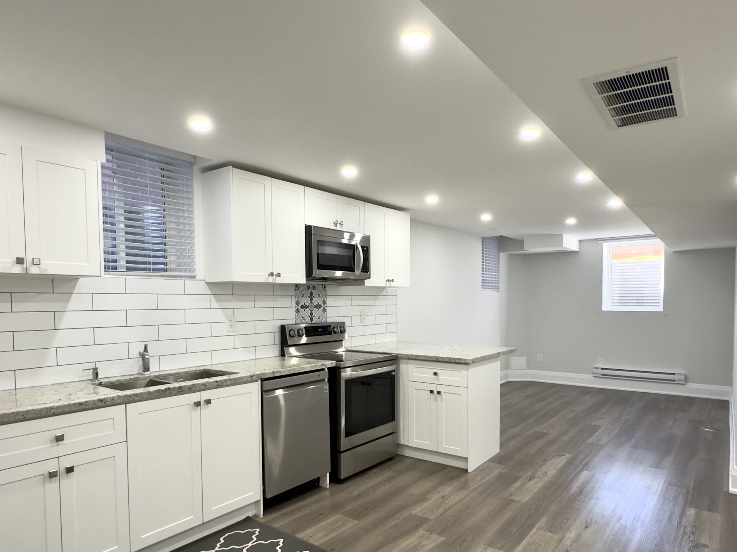 Open concept living area and kitchen in a legal basement apartment in Vaughan, Ontario.