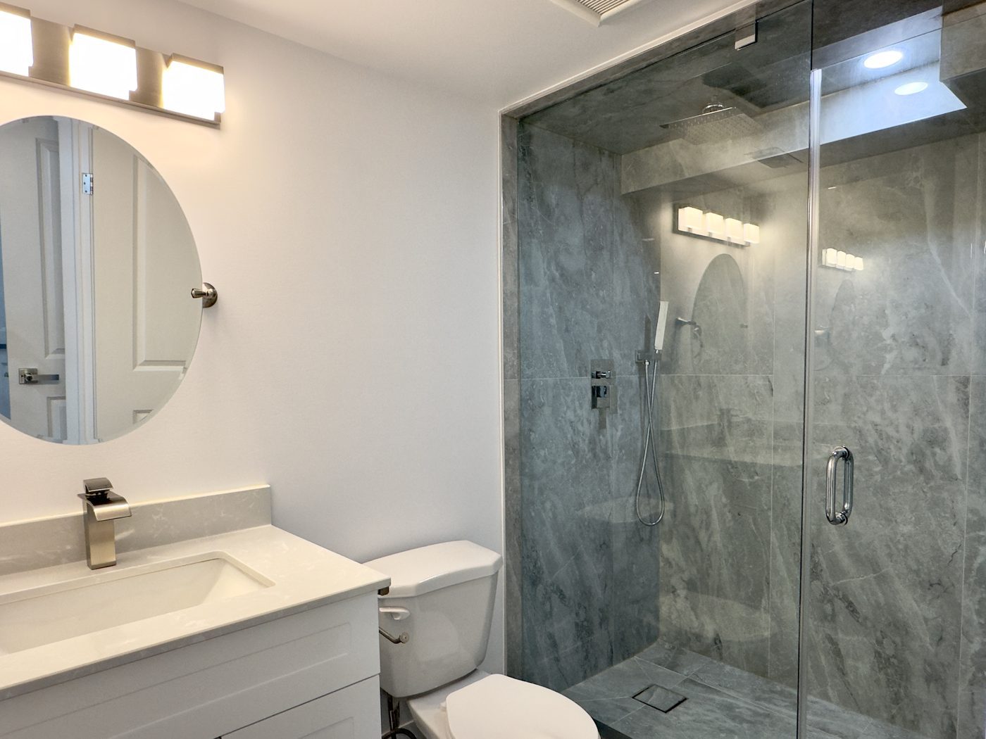Three-piece bathroom with a glass shower in a legal basement second suite