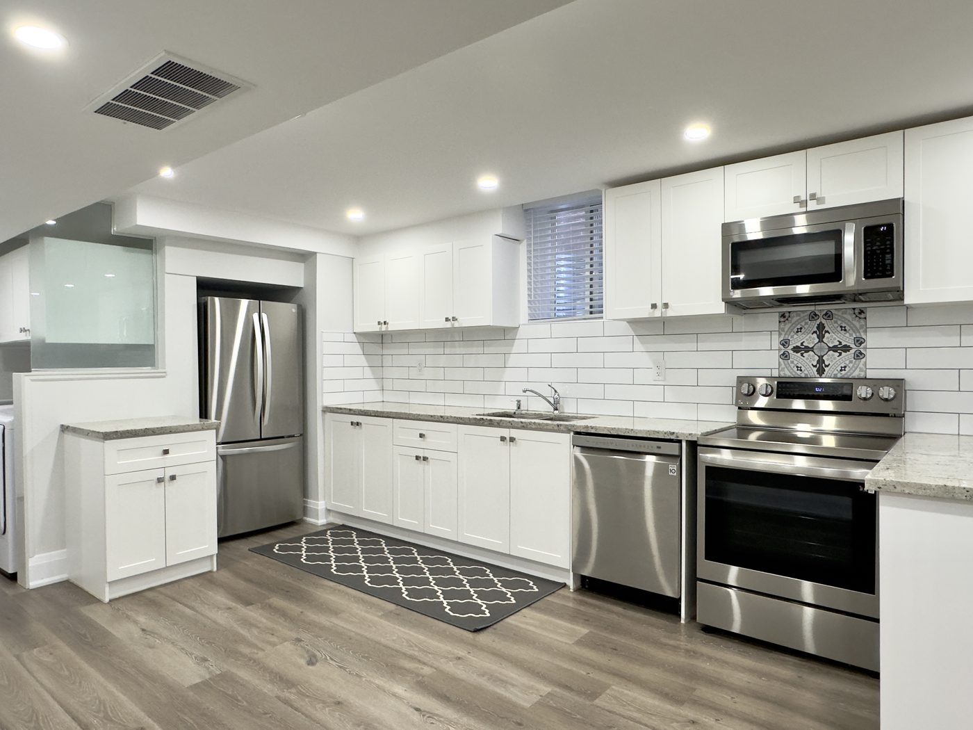 Self-contained kitchen with full-size appliances in a second unit
