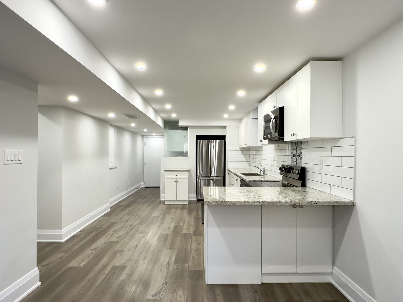 Bedroom in a legal basement apartment with an enlarged window and window well