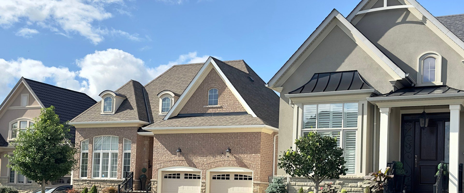 Large detached homes with landscaped front gardens on a quiet residential street in Caledon, Ontario